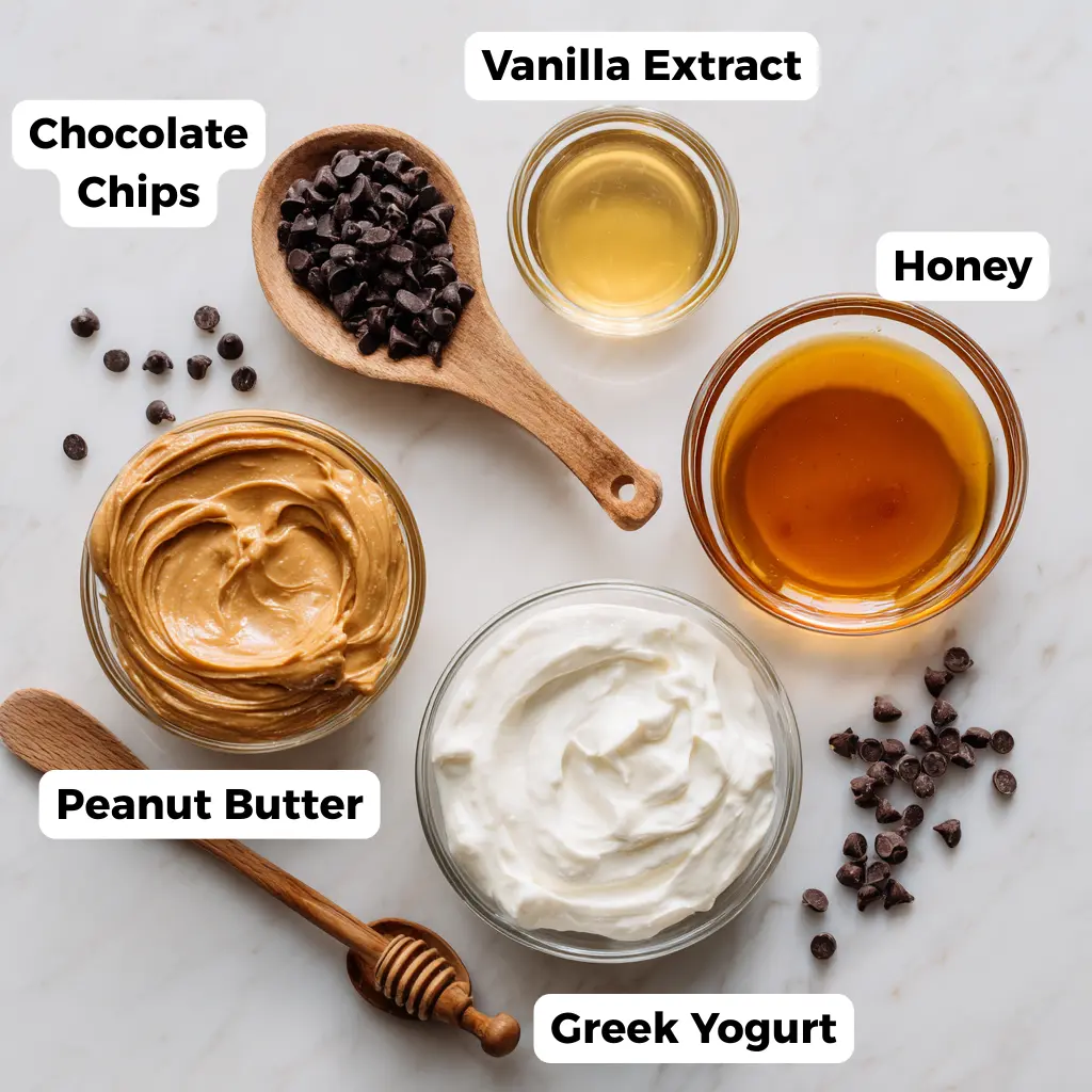 Dreamy Peanut Butter Frozen Yogurt Bars: Perfect Summer Snack 2 Flat lay of yogurt, peanut butter, honey, and chocolate chips on marble